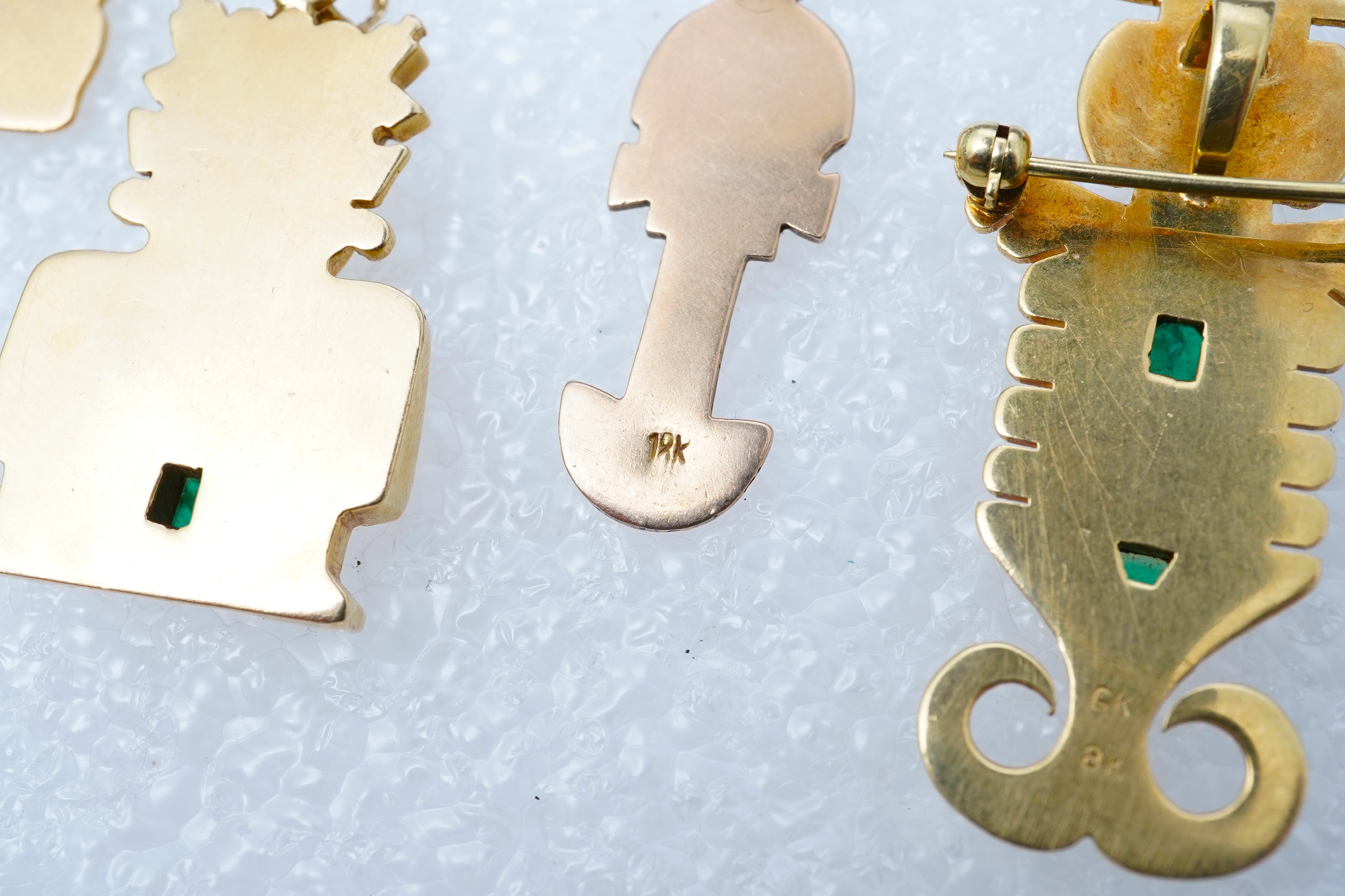 A collection of five gold pendants